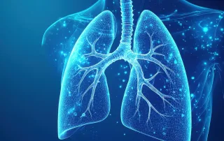 Digital illustration of human lungs and trachea, glowing blue, featuring detailed bronchial tubes and chest anatomy. AlignRT technology inspires the precision showcased against a dark background.